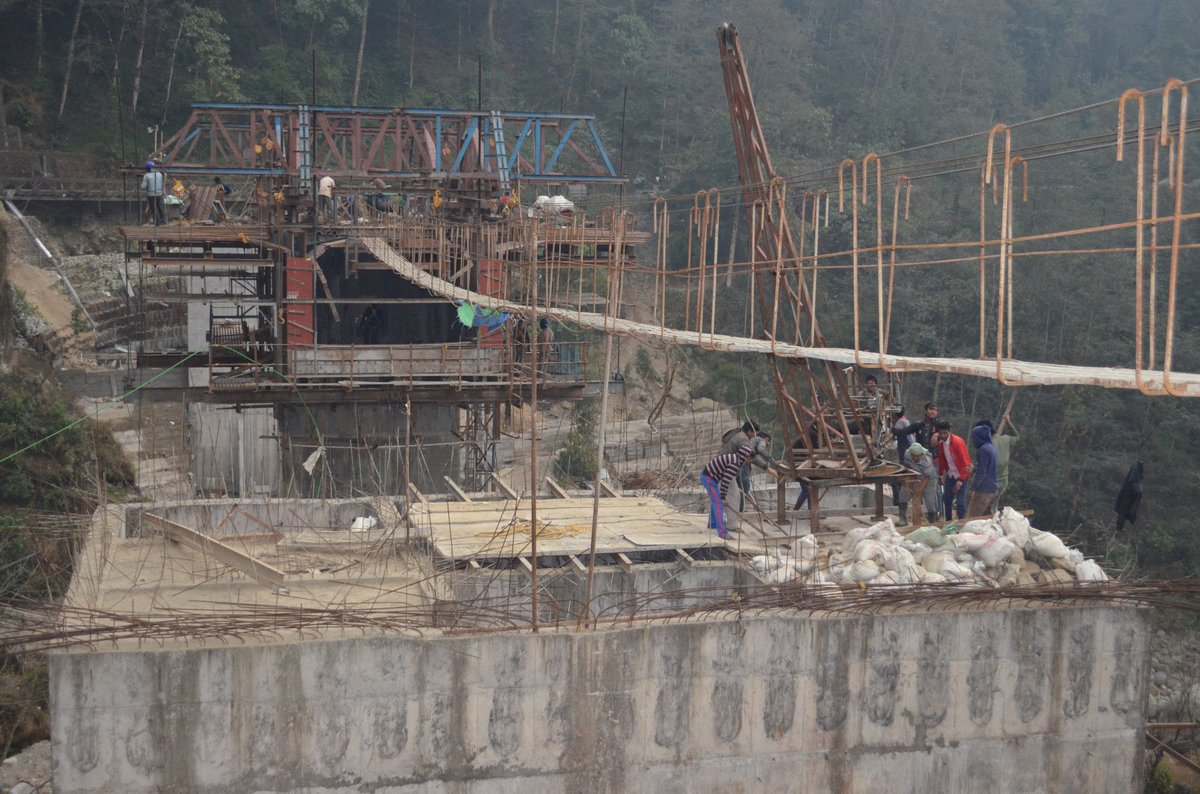 Bakcha Khola Bridge — Workers on deck with suspension footbridge